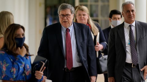 Attorney General William Barr, center, arrives for an event on police reform last month at the White House. Barr is expected to face tough questioning when he appears Tuesday before the House Judiciary Committee.