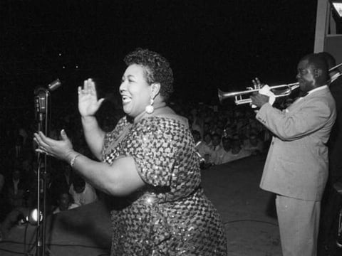 Velma Middleton is accompanied by Louis Armstrong at the 1955 Newport Jazz Festival.