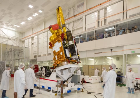 NASA's Soil Moisture Active Passive (SMAP) spacecraft is slowly lowered into place in the Spacecraft Assembly Facility at NASA's Jet Propulsion Laboratory, Pasadena, California