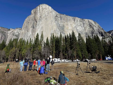 Spectators gaze at El Capitan for a glimpse of climbers Tommy Caldwell and Kevin Jorgeson on Wednesday, Jan. 14, 2015, as seen from the valley floor in Yosemite National Park, Calif.