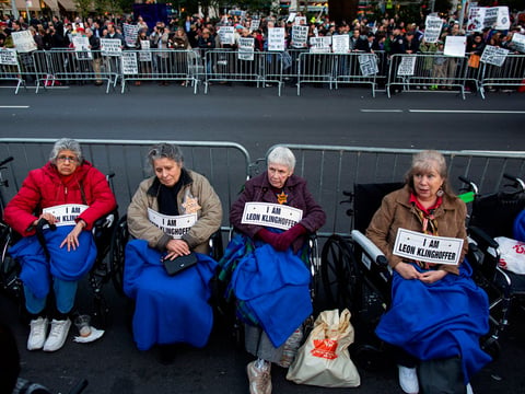 People, some in wheelchairs, gather at Lincoln Center as they protest "Death of Klinghoffer" Monday, Oct. 20, 2014, in New York. American composer John Adams' opera has been a lightning rod since February, when it was first scheduled for this season.