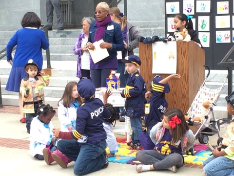Children gather in front of a podium before a press conference at the Capitol on expanded child care on Wednesday, Feb. 2, 2015.
