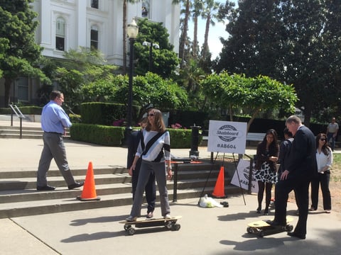 Assembly Minority Leader Kristin Olsen (R-Modesto) and Asm. Mark Stone (D-Santa Cruz) try riding electric skateboards outside the state Capitol Monday.