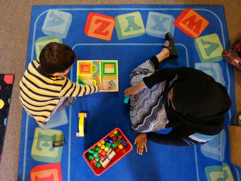 Declan Hart, 4, left, and teacher-in-training Deassi Usman, right, play with shape blocks during a Pre-Kindergarten class at the Community Day Center for Children, during class Tuesday, Oct. 21, 2014, in Seattle.