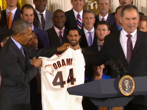 Giants manager Bruce Bochy gives President Barack Obama a souvenir baseball jersey during today's press conference. 