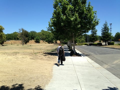 A homeless man walks across the entryway to what was the Old Town Inn in West Sacramento. The inn served as temporary shelter for some of the area's homeless under a pilot program before the hotel was torn down.