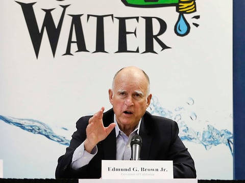 FILE- In this April 16, 2015, file photo, California Gov. Jerry Brown talks with reporters after a meeting about the drought at his Capitol office in Sacramento, Calif. 