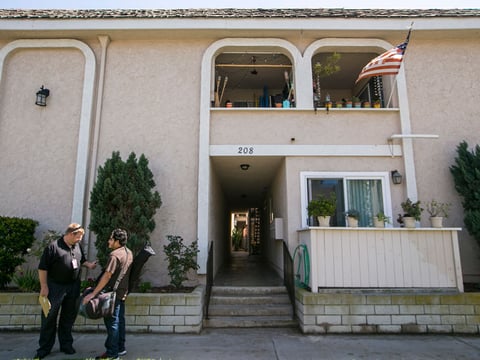 Members of the media gather at a location where a missing woman was found safe in Huntington Beach, Calif., on Wednesday, March 25, 2015.  