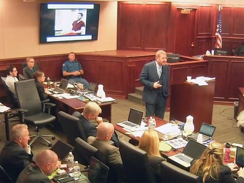 In this image taken from video, accused Colorado theater shooter James Holmes, on the upper far left, listens to defense attorney Daniel King give closing arguments during Holmes' trial in Centennial, Colo., on July 14.