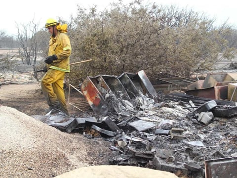 Fire debris is seen on the side of the road, as transit is open on the southbound 15 Freeway in the Cajon Pass, Calif., on Saturday, July 18, 2015.