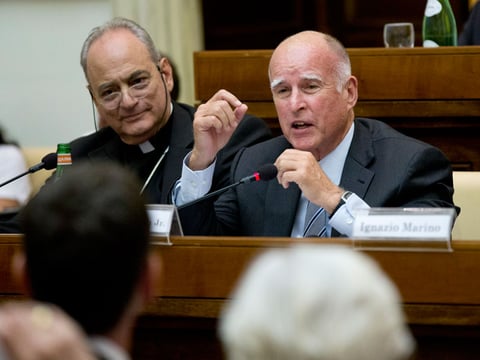 Gov. Jerry Brown, right, delivers his speech flanked by the head of the pontifical academy of Science, Bishop Marcelo Sanchez Sorondo, during a conference on Modern Slavery and Climate Change in the Casina Pio IV the Vatican, July 22, 2015.