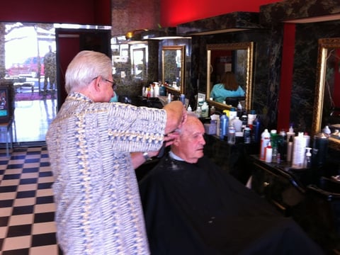 Robert Pollard cuts Gene Cronin's hair Thursday August 15, 2013.