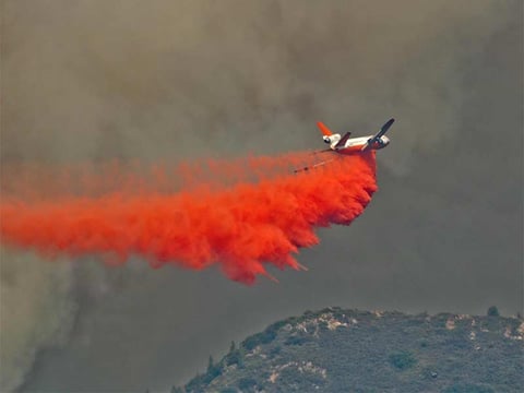 Tanker drops retardant along the Hwy 180 area on the Rough Fire, Tuesday, Aug. 18, 2015.