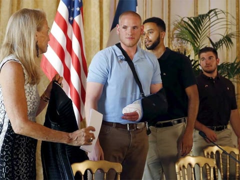U.S. ambassador to France Jane Hartley presents U.S Airman First Class Spencer Stone, student Anthony Sadler and National Guardsman Alek Skarlatos (left to right) as they attend a news conference at the U.S. Embassy in Paris, France, on Sunday.
