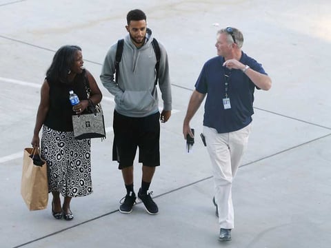 Anthony Sadler, center, who helped stop a terror attack on a high-speed train traveling from Amsterdam to Paris, walks across the tarmac to a waiting vehicle at Sacramento International Airport, Tuesday, Aug. 25, 2015.
