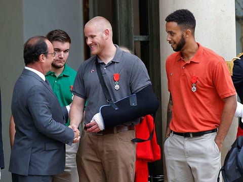French President Francois Hollande bids farewell to U.S. Airman Spencer Stone as U.S. National Guardsman Alek Skarlatos of Roseburg, Ore., second from left, and Anthony Sadler, a senior at Sac State, right, look on, on Monday, Aug. 24, 2015.