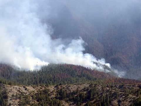 Smoke rises from the Gasquet Complex Fire on Monday, Sept. 7, 2015. 