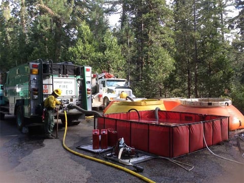 Crews on the Rough Fire fill fire trucks with water from Porta-Tanks on Thursday, Sept. 16, 2015.
