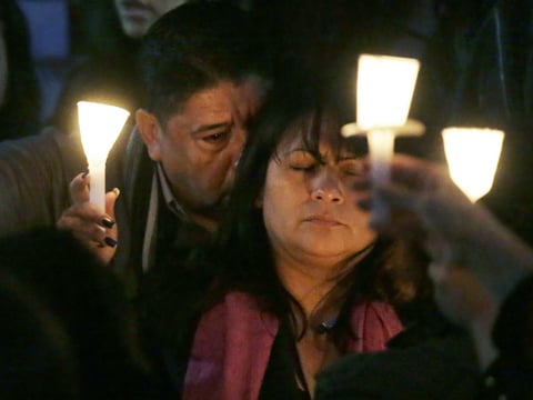 Beatrez Gonzalez, right, mother of California State Long Beach student Nohemi Gonzalez holds up candle with Nohemi's step-father Jose Hernandez, left, during a memorial service on Sunday, Nov. 15, 2015 in Long Beach, Calif., for Gonzalez.