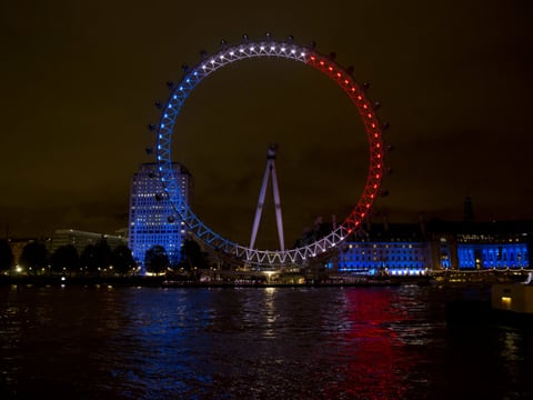 The London Eye ferris wheel is lit up in the colors of the French flag in solidarity with France after the deadly attacks in Paris, in London, Saturday, Nov. 14, 2015. 