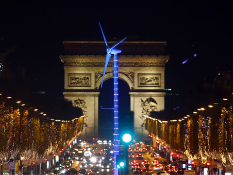 A power-generating windmill turbine is seen on the Champs Elysees avenue with the Arc de Triomphe in background as part of the COP21, United Nations Climate Change Conference, in Paris, Wednesday, Dec. 2, 2015.