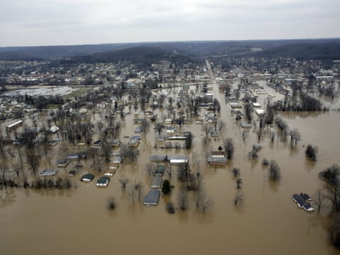 In this aerial photo, flood water surrounds business and homes Wednesday, Dec. 30, 2015, in Pacific, Mo.