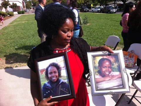 Mary Murigi holds pictures of her daughter, Michelle.  Michelle was killed in January 2012 while walking in a crosswalk at 58th and Fruitridge in south Sacramento. 