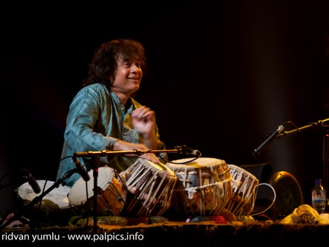 Photo of Zakir Hussain playing tabla.