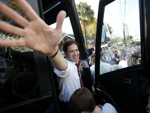Marco Rubio waves as he boards his bus after a campaign stop in Lakeland, Fla., on Saturday.
