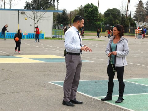 Principal Daniel Rolleri checks in with the school’s behavioral specialist during recess at Oak Ridge Elementary.