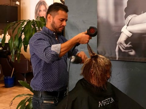 Gustavo Bedolla at work in his San Jose hair salon. He’ll vote for the first time this election, and he wants more Latinos to do the same. 