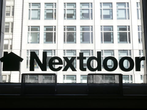A Nextdoor sign is shown in a window at an office in San Francisco, Wednesday, May 11, 2016. 