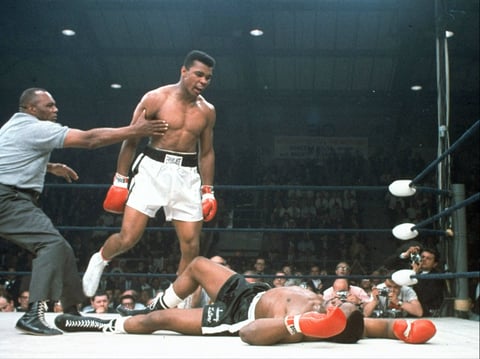 Heavyweight champion Muhammad Ali stands over fallen challenger Sonny Liston, shouting and gesturing shortly after dropping Liston with a short hard right to the jaw on May 25, 1965, in Lewiston, Maine.