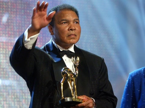 Former heavyweight boxing legend Muhammad Ali waves to the audience after receiving the "Bambi Trophy" during the Bambi Media Award in Hamburg, northern Germany, Thursday evening, Nov. 27, 2003.  