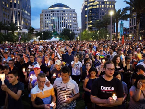 Crowd members hold candles during a vigil downtown for the victims of a mass shooting at the Pulse nightclub Monday, June 13, 2016, in Orlando, Fla. (AP Photo/David Goldman)

