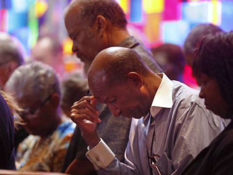Members of Together Baton Rouge bow their heads in prayer at the start of a news conference, regarding the recent shooting of Alton Sterling, in Baton Rouge, La., Thursday, July 7, 2016. 
