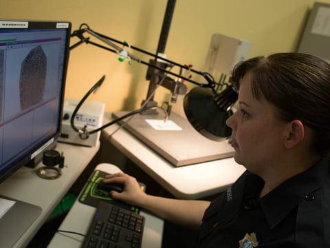 Forensic Investigator, Theresa Langhus, demonstrates how fingerprints found at crime scenes are compared with those on file on Wednesday, August 10, 2016.  