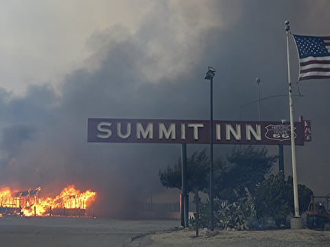 This Tuesday, Aug. 16, 2016 photo shows the Summit Inn, a popular roadside diner at the crest of historic Route 66 in Oak Hills, Calif. burns to the ground after a fast burning wildfire swept through the town. 