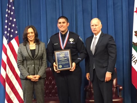San Bernardino Police Officer Nicholas Koahou poses for a photo with Gov. Jerry Brown and Attorney General Kamala Harris after receiving the Medal of Valor in a ceremony at the state Capitol on Monday, Sept. 12, 2016.