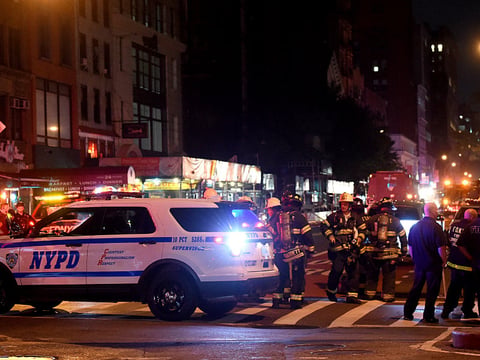 Police officers and firefighters respond to an explosion on Saturday at 23rd Street and 7th Avenue in the Chelsea neighborhood of New York City. Authorities say more than two dozen people have been taken to hospitals with injuries, none of which are thought to be life threatening.