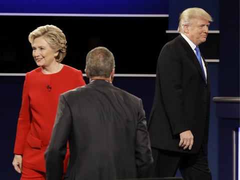 Democratic presidential nominee Hillary Clinton and Republican presidential nominee Donald Trump walk their separate ways after the presidential debate at Hofstra University in Hempstead, N.Y., Monday, Sept. 26, 2016. 