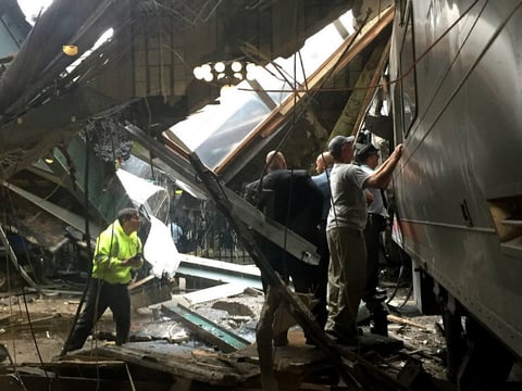 Train personnel survey the NJ Transit train that crashed in to the platform at the Hoboken Terminal on Thursday.