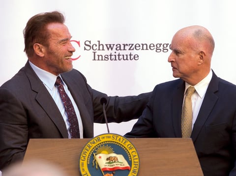 Former Gov. Arnold Schwarzenegger, left, shakes hands with Gov. Jerry Brown during a celebration of the 10th Anniversary of Schwarzenegger signing California's landmark global warming bill, AB32, Wednesday, Oct. 5, 2016, in Sacramento, Calif.
