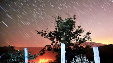 Perseid meteors streak across the sky over the city of Inegol in Turkey's Bursa Province in August 2015.