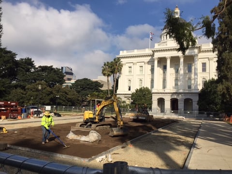 A construction crew levels dirt across what used to be a broad patch of grass on the south side of the California state Capitol building in downtown Sacramento in December 2016.