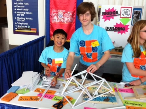 Caleb Leung (left) and Scully Randlett, 7th graders at Alice Fong Yu K-8 Chinese Immersion School in San Francisco, build a cantilever bridge Monday using paper rolls and scotch tape at the STEM Symposium in Sacramento.