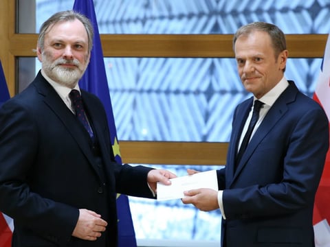 British Ambassador to the EU Tim Barrow (left) delivers Prime Minister Theresa May's formal notice of the U.K.'s intention to leave the bloc to European Council President Donald Tusk in Brussels on Wednesday.