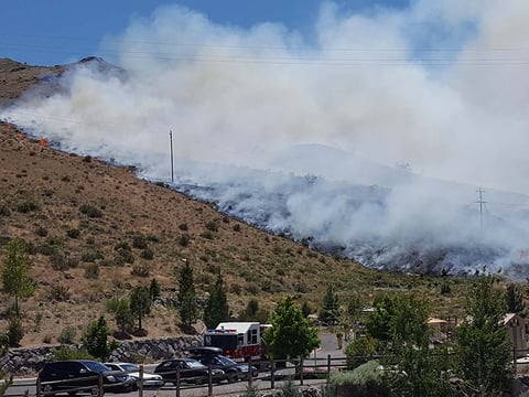 A brush fire burns at the Hunter Creek trail head in western Reno, Nevada.