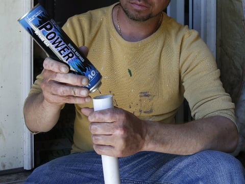 In this May 1, 2014 photo, a man who suffered severe burns to 12 percent of his body when butane fumes ignited while he was making hash oil at home, demonstrates how he made the marijuana concentrate, at his home in Denver. 