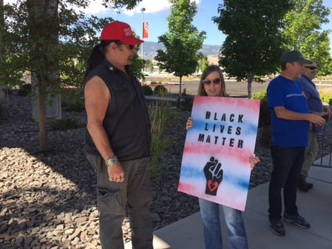 Trump supporter Kevin Coffey and protester Cathy Blane, both of Reno, chat outside the Reno Convention Center on Wednesday, August 23, 2017, while the president addressed the American Legion National Convention inside.